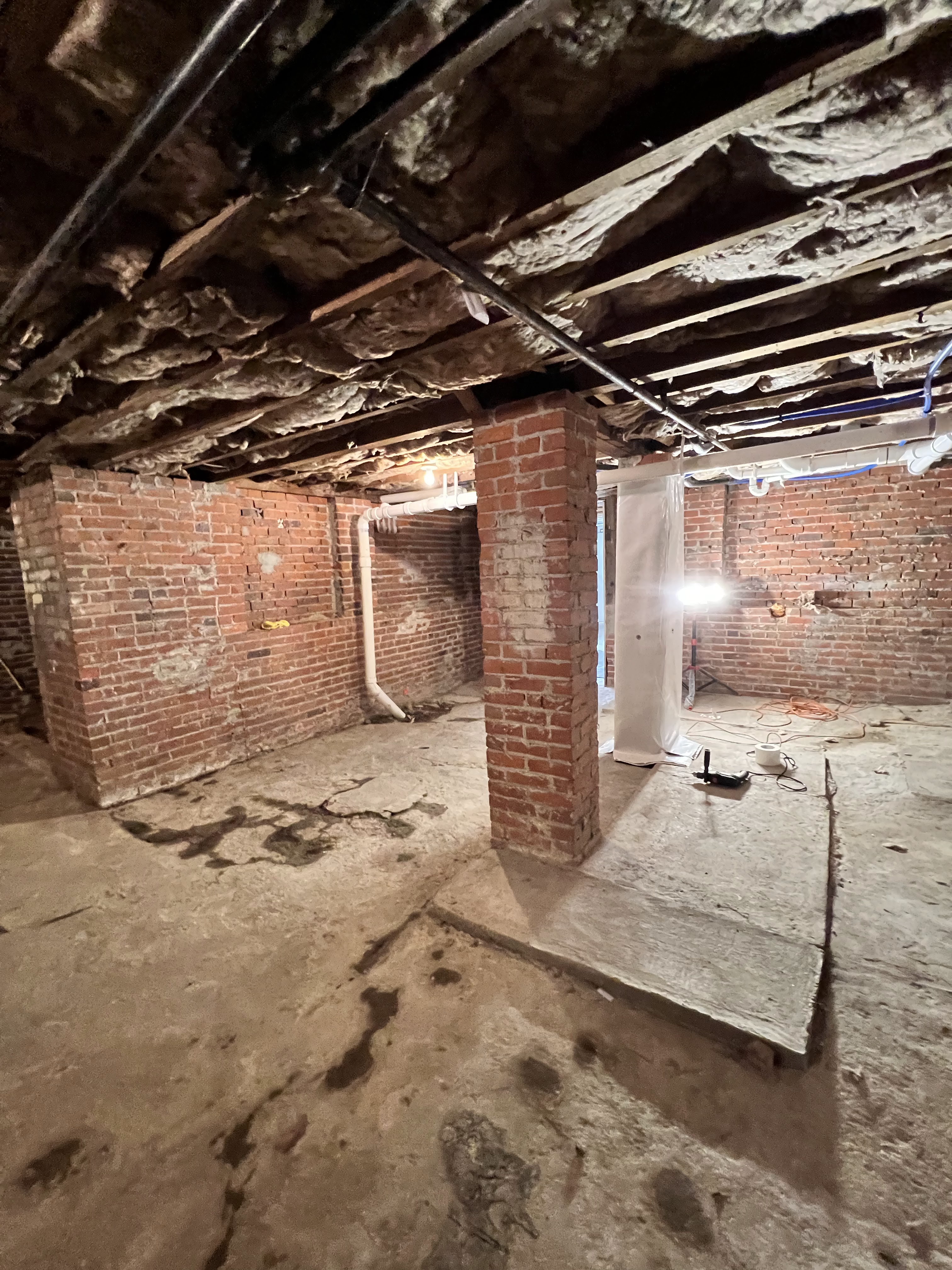 Crawlspace after full encapsulation — clean white vapor barrier