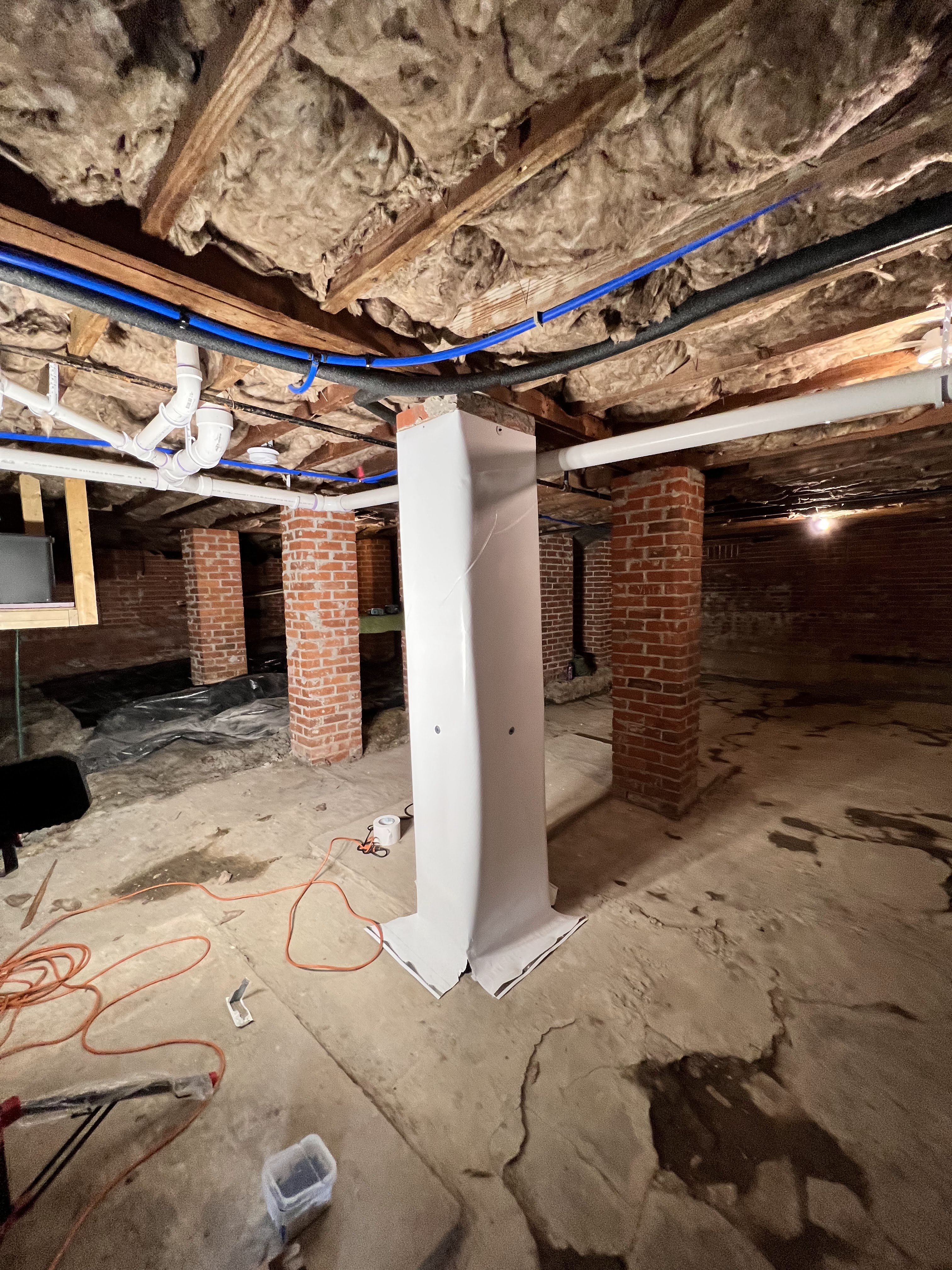 Crawlspace after encapsulation — humidity monitor installed