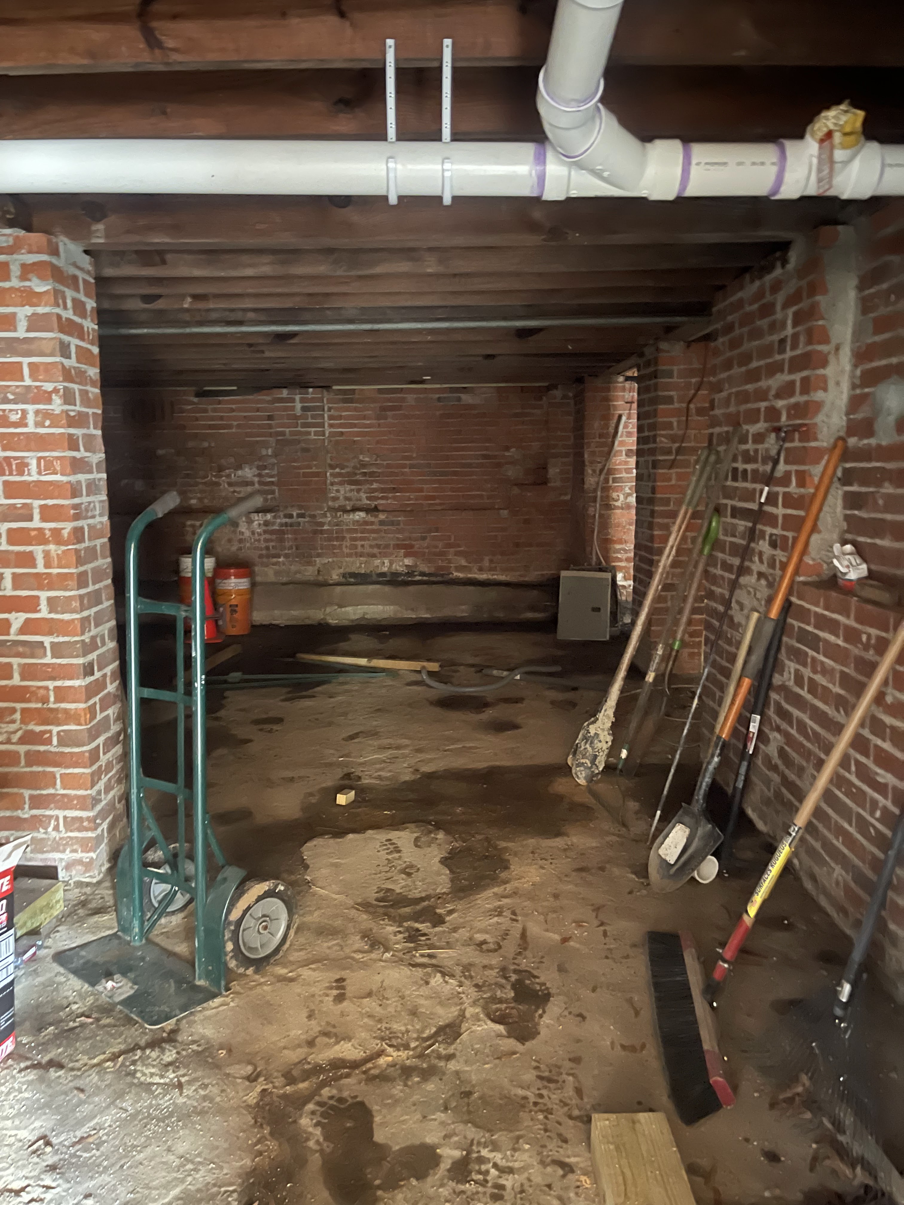 Vapor barrier being installed on crawlspace walls